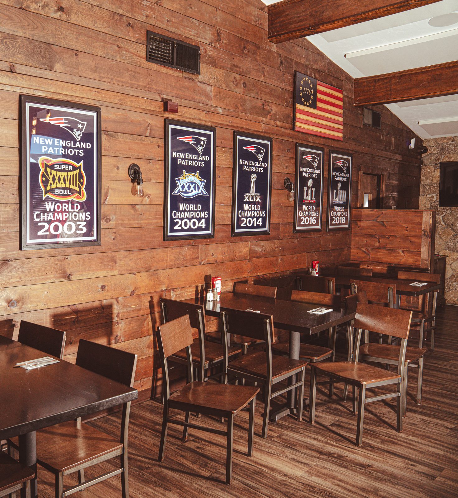 The dining room, wood walls and Patriots championship prints