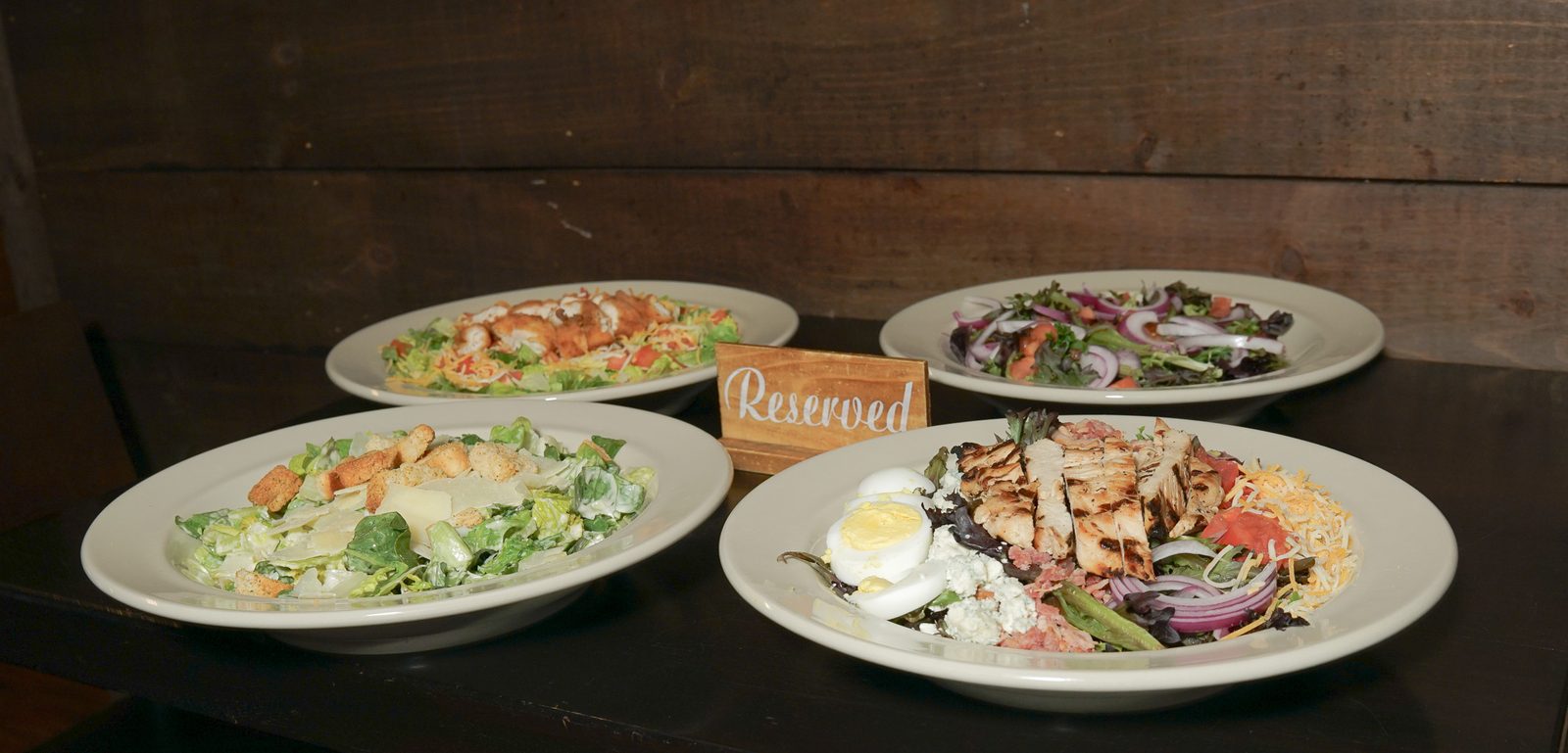 Four salads on a table